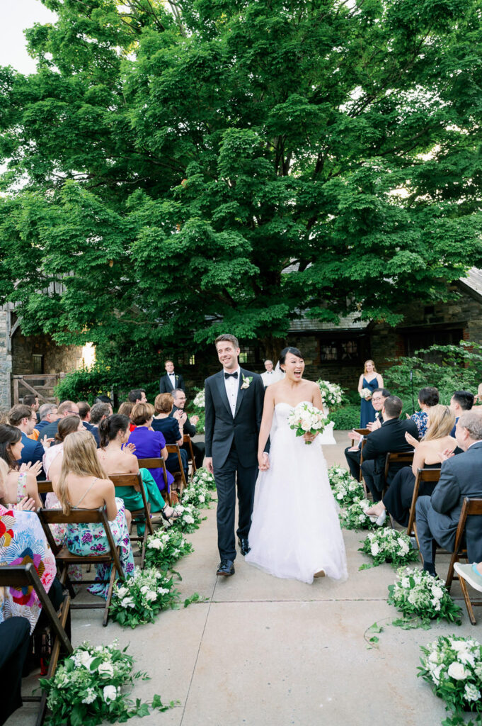 Outdoor wedding ceremony at Blue Hill at Stone Barns, Tarrytown, NY, with flowers by Bedford Village Flower Shoppe
